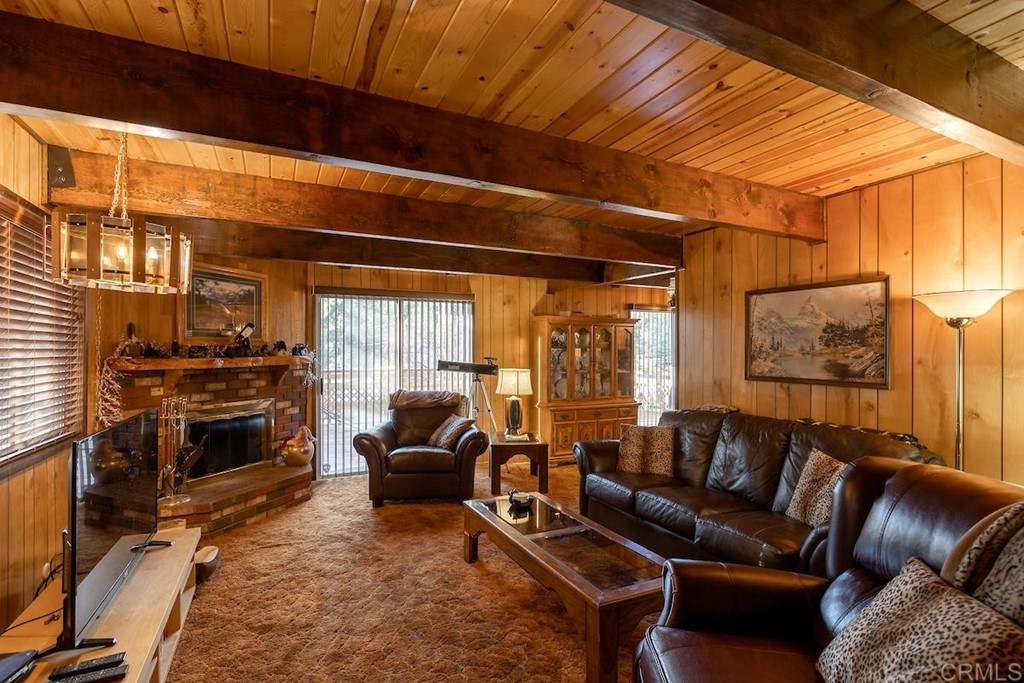 42535 Avalon Road Big Bear Lake, CA 92315 - Photo 7 of 26 a living room with furniture a fireplace and a flat screen tv
