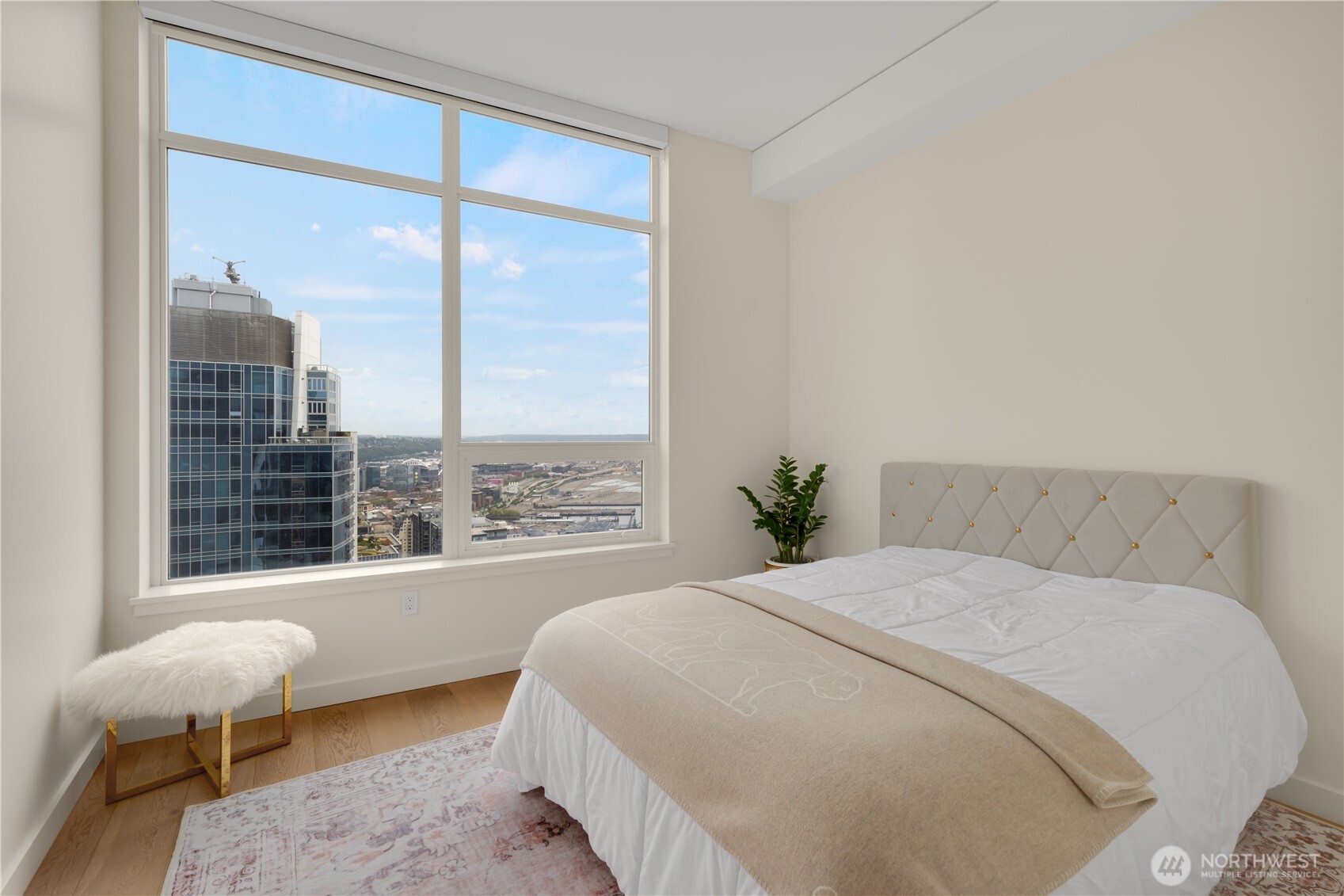 121 Stewart Street, Unit 3504 Seattle, WA 98101 - Photo 20 of 31 a large bed sitting in a bedroom next to a window