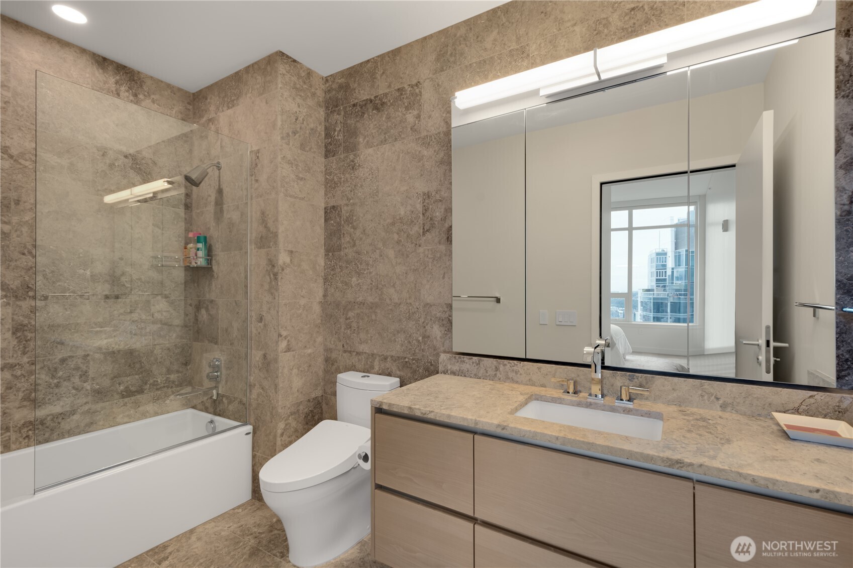 121 Stewart Street, Unit 3504 Seattle, WA 98101 - Photo 21 of 31 a bathroom with a granite countertop sink toilet and shower