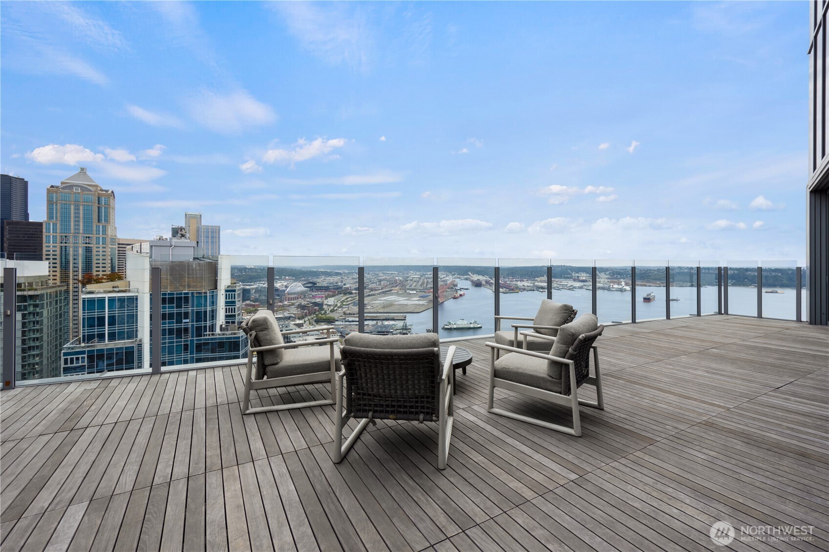 121 Stewart Street, Unit 3504 Seattle, WA 98101 - Photo 29 of 31 a roof deck with a table and chairs