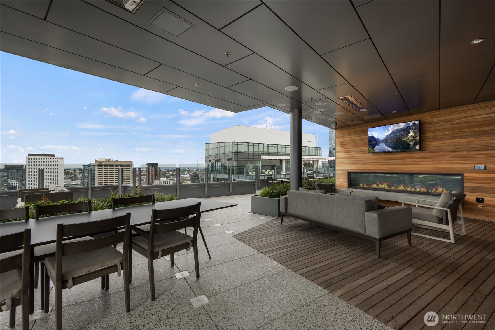 121 Stewart Street, Unit 3504 Seattle, WA 98101 - Photo 9 of 31 a roof deck with table and chairs a barbeque