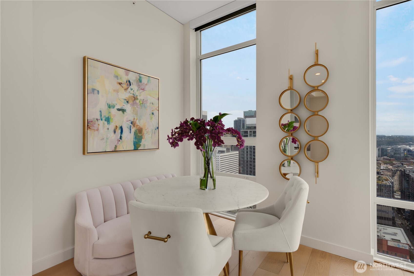 121 Stewart Street, Unit 3504 Seattle, WA 98101 - Photo 10 of 31 a view of a dining room with furniture and wooden floor