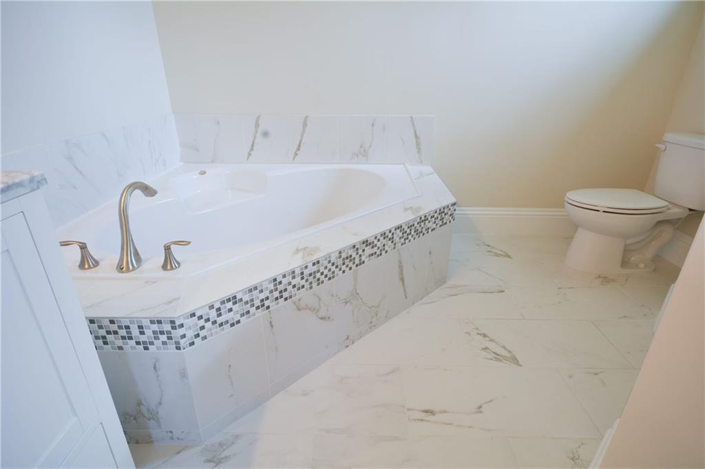 2035 Northwest Fork Road Stuart, FL 34994 - Photo 8 of 37 a bathroom with a sink and a toilet