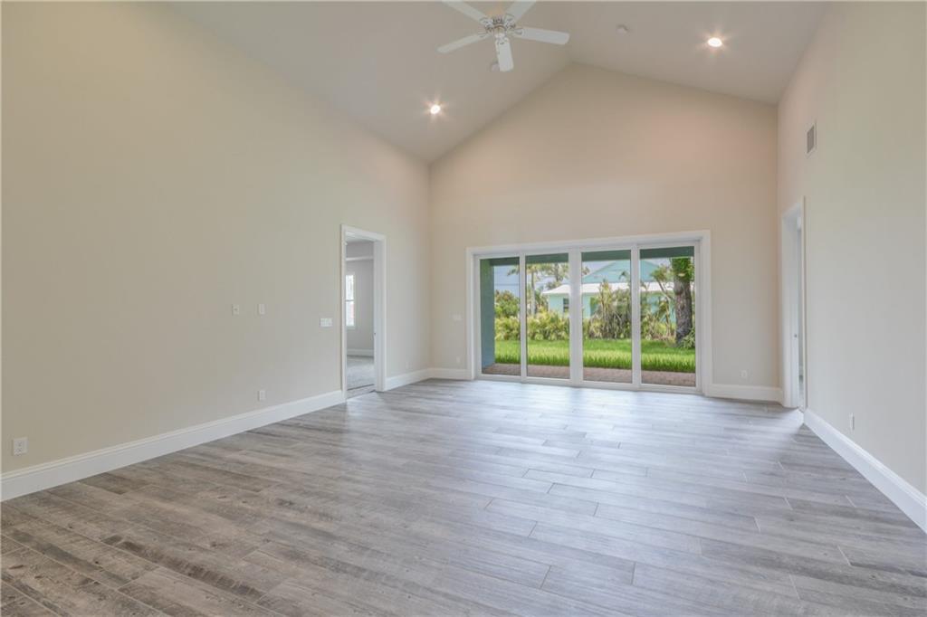 2035 Northwest Fork Road Stuart, FL 34994 - Photo 10 of 37 an empty room with wooden floor and a window