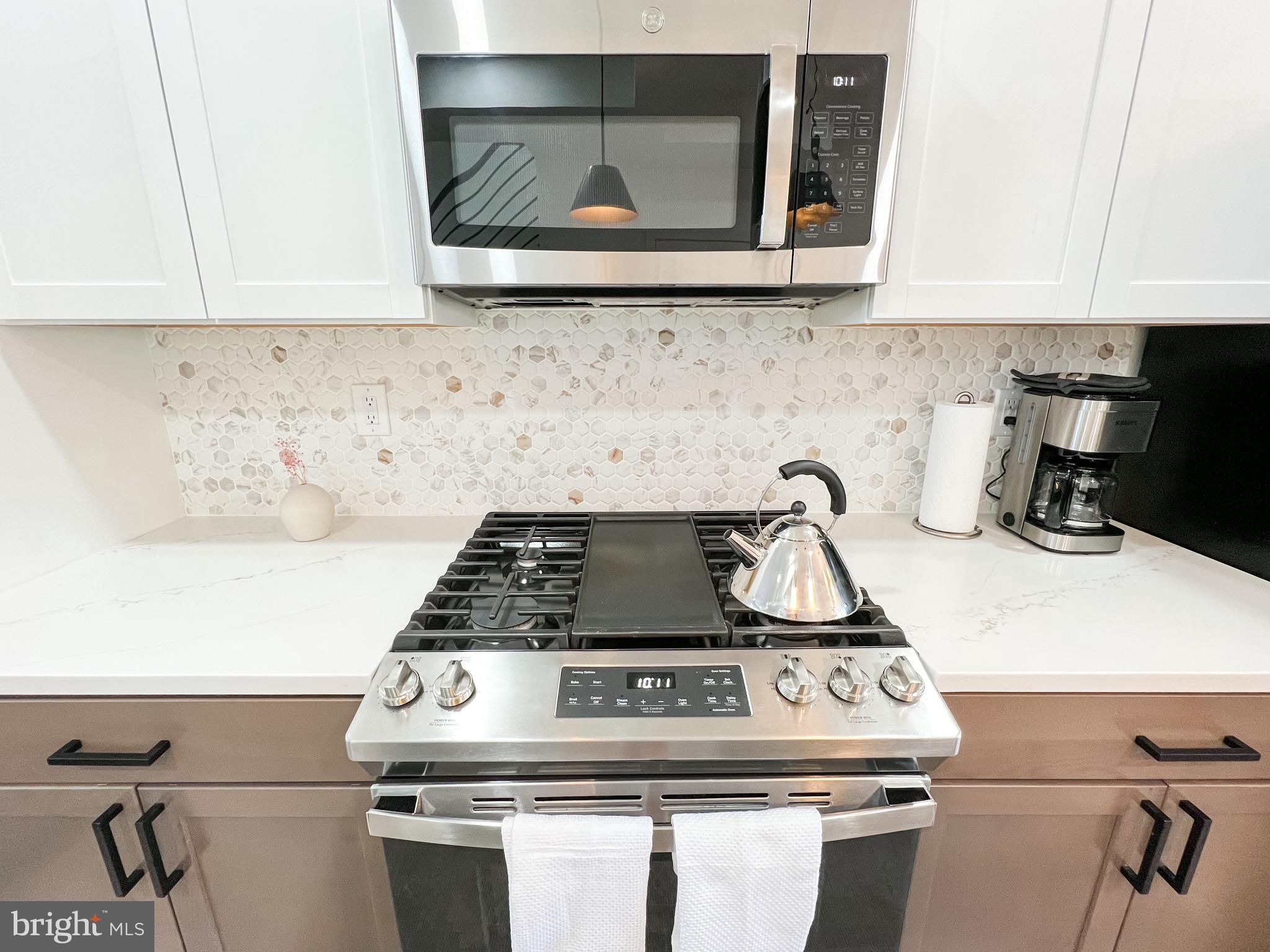 3424 9th Street Northeast Washington, DC 20017 - Photo 11 of 32 a stove top oven sitting inside of a kitchen