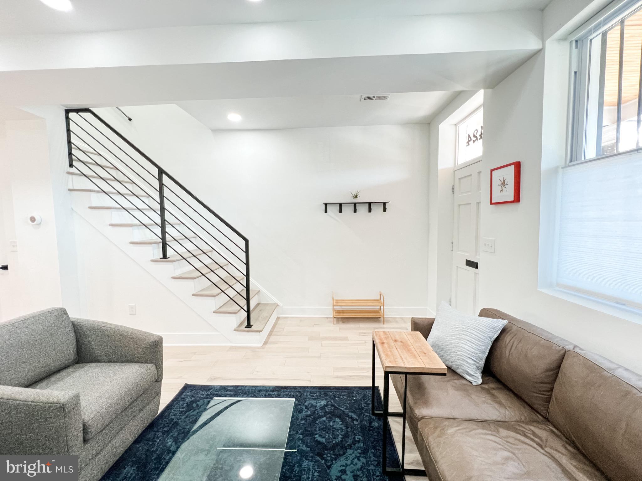 3424 9th Street Northeast Washington, DC 20017 - Photo 13 of 32 a living room with furniture and a rug
