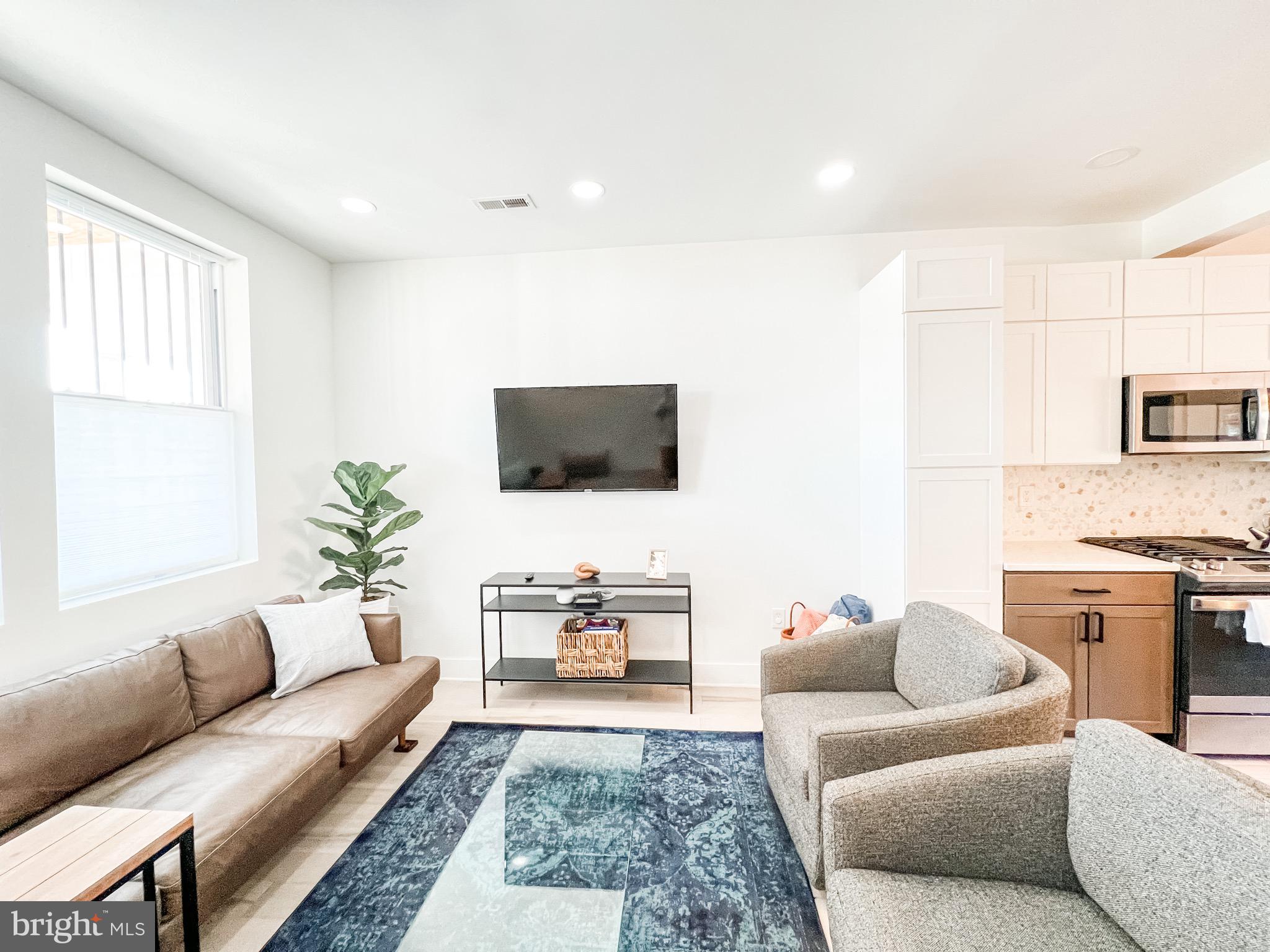 3424 9th Street Northeast Washington, DC 20017 - Photo 2 of 32 a living room with furniture and a flat screen tv