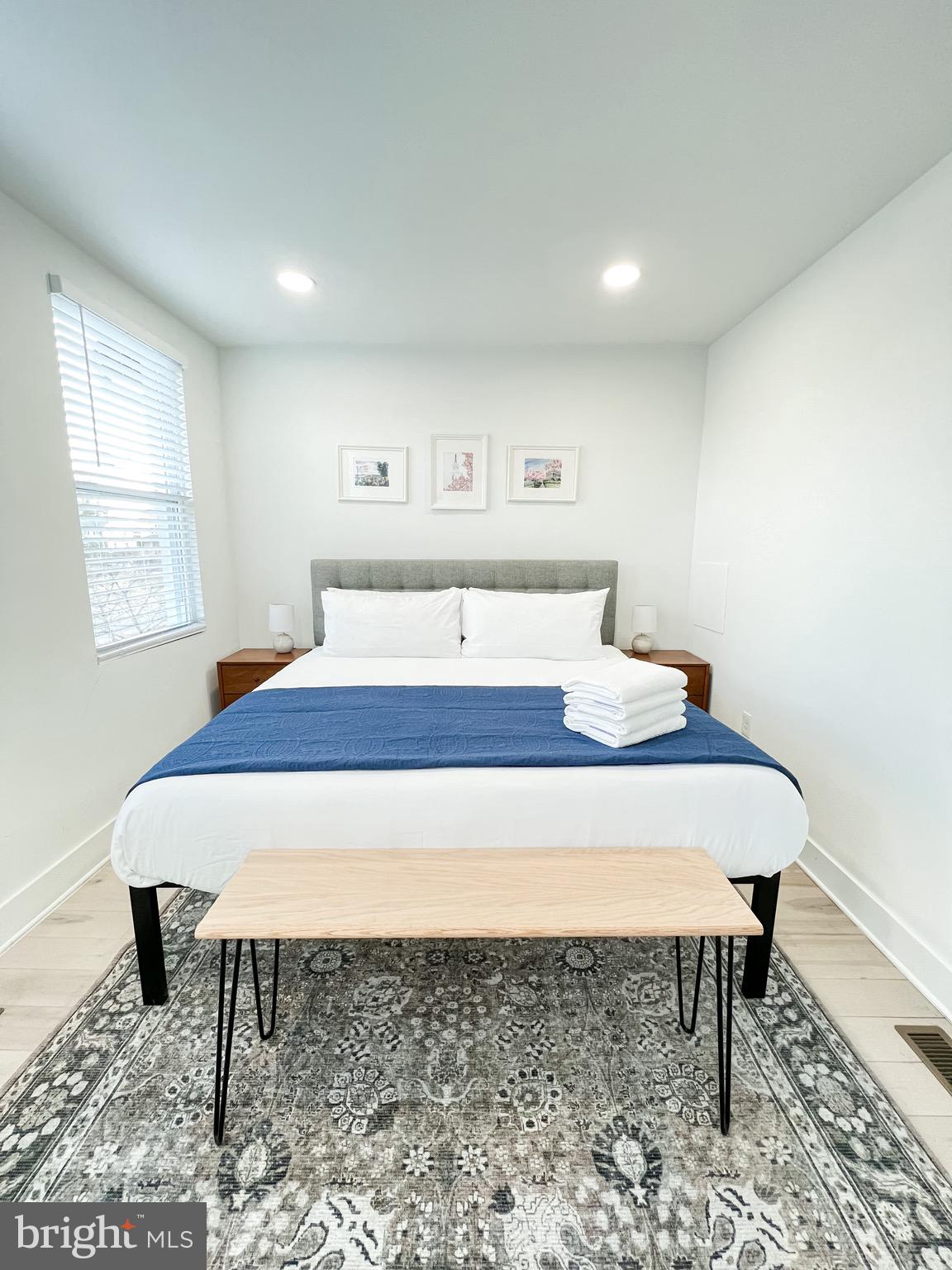 3424 9th Street Northeast Washington, DC 20017 - Photo 25 of 32 a bedroom with a bed and a table in it