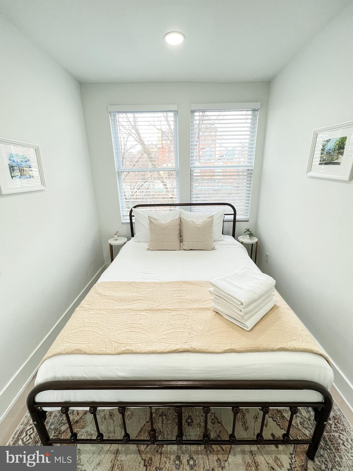 3424 9th Street Northeast Washington, DC 20017 - Photo 31 of 32 a bedroom with a bed and wooden floor