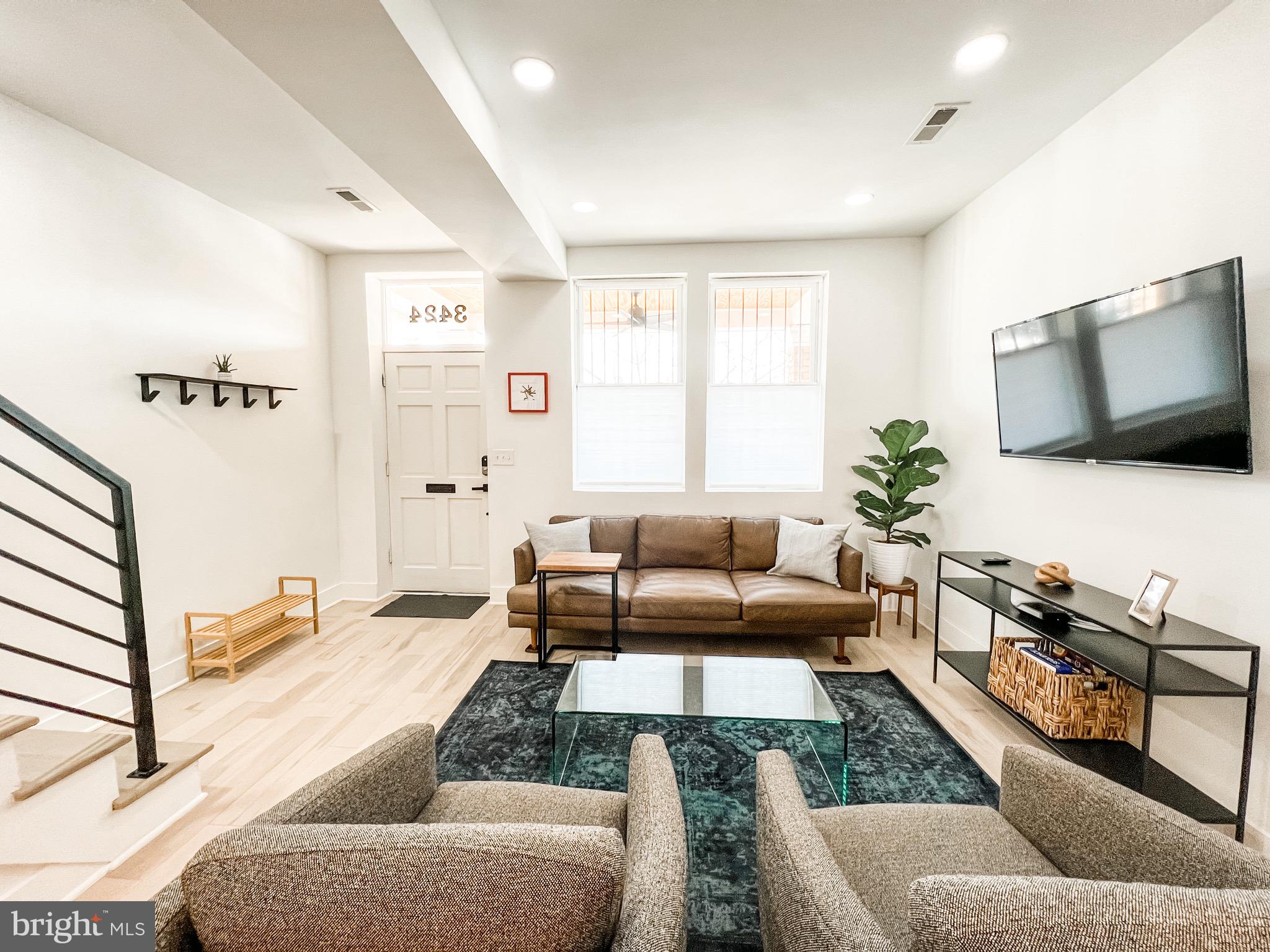 3424 9th Street Northeast Washington, DC 20017 - Photo 6 of 32 a living room with furniture and a flat screen tv