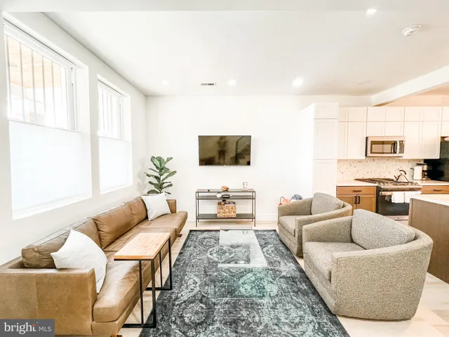 a kitchen with granite countertop a stove top oven microwave and cabinets
