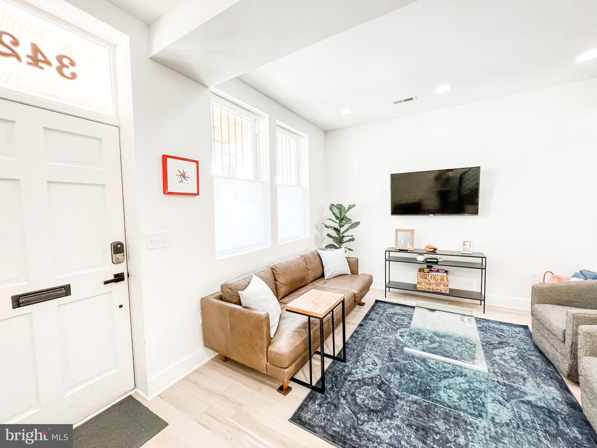 3424 9th Street Northeast Washington, DC 20017 - Photo 9 of 32 a living room with furniture and a flat screen tv
