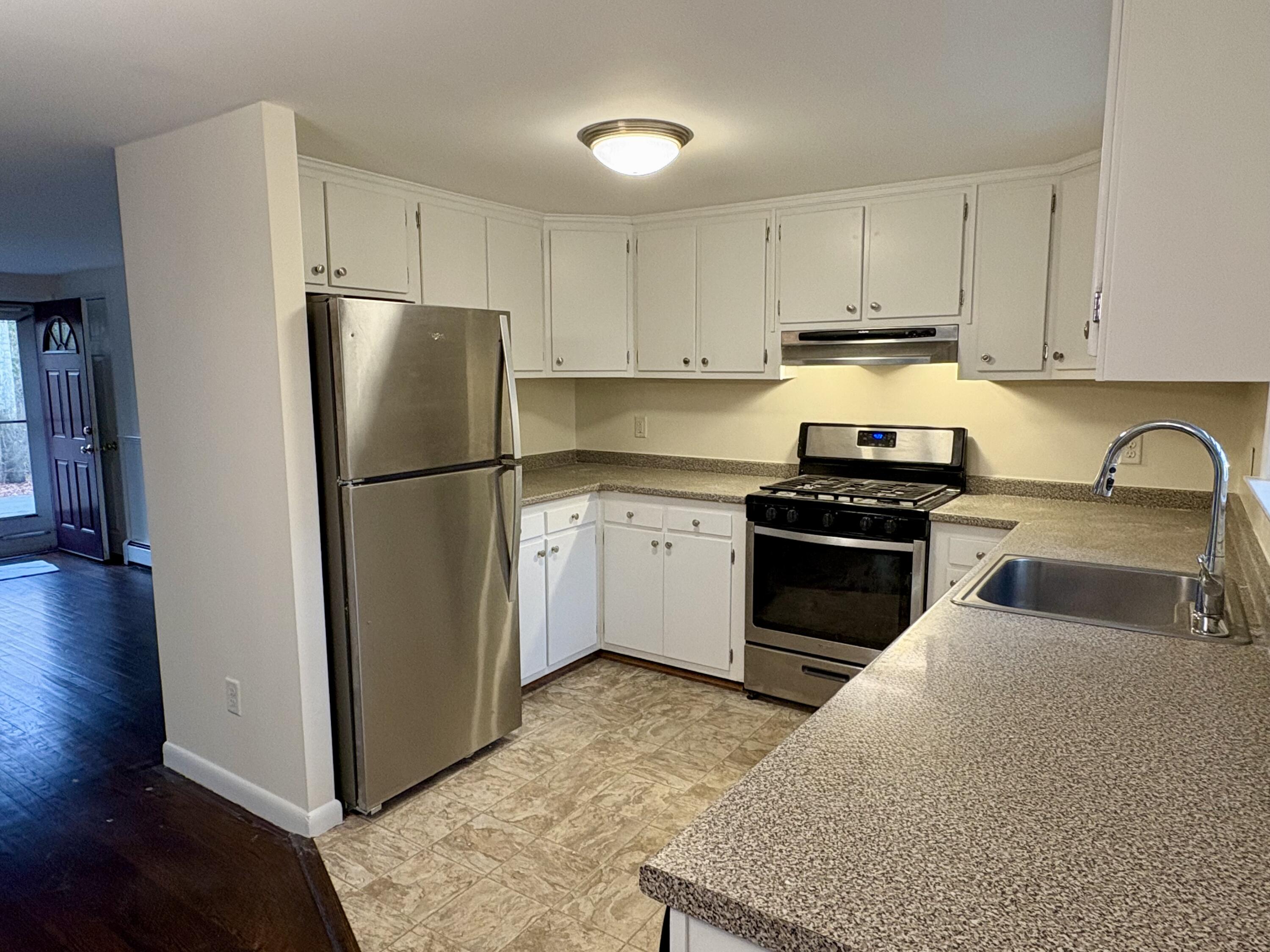 55 Chickadee Lane Centerville, MA 02632 - Photo 11 of 26 a kitchen with a refrigerator sink and cabinets