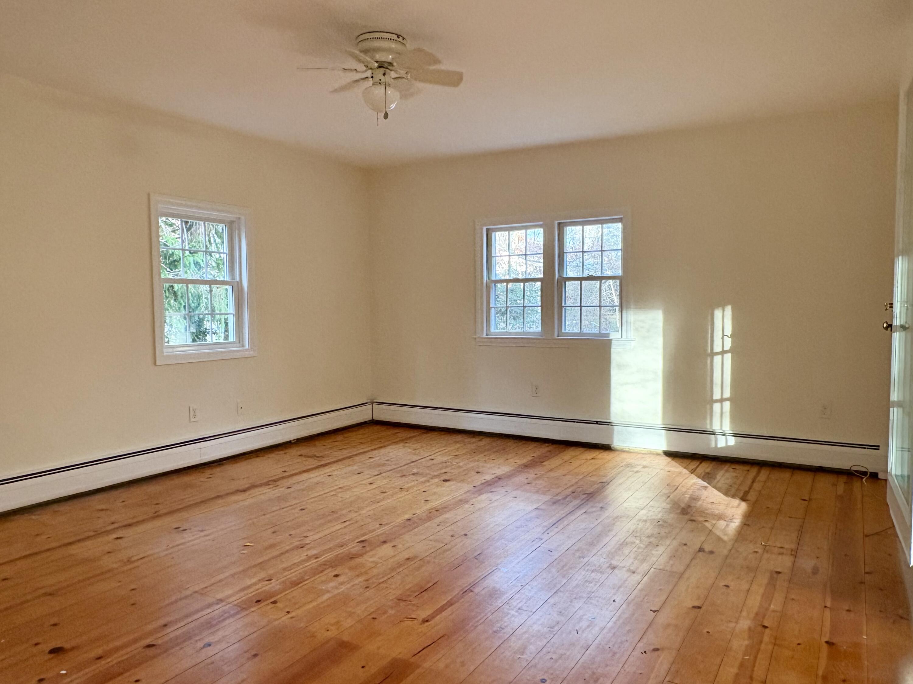 55 Chickadee Lane Centerville, MA 02632 - Photo 12 of 26 a view of an empty room with wooden floor and a window