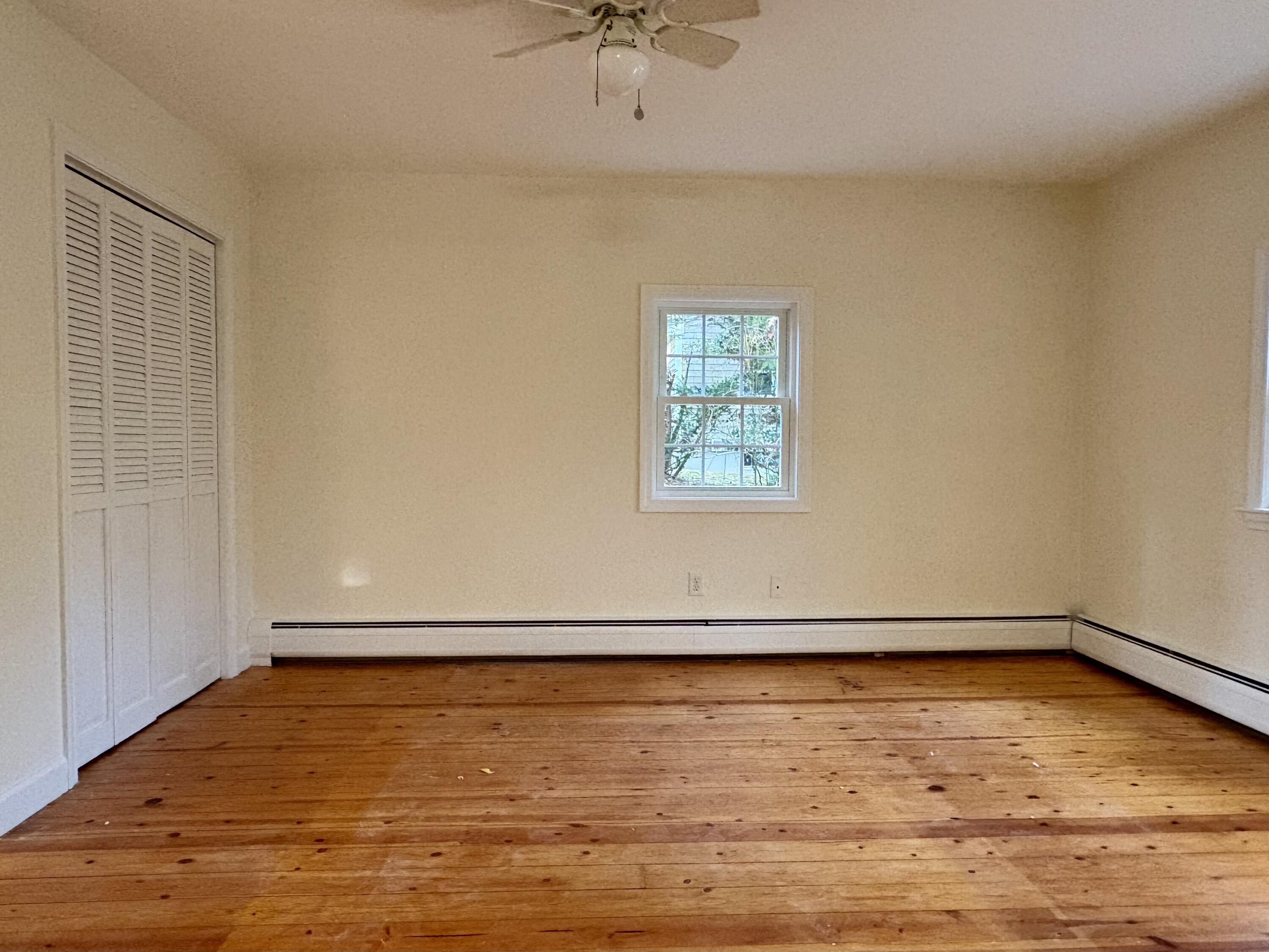 55 Chickadee Lane Centerville, MA 02632 - Photo 13 of 26 an empty room with a window and a ceiling fan