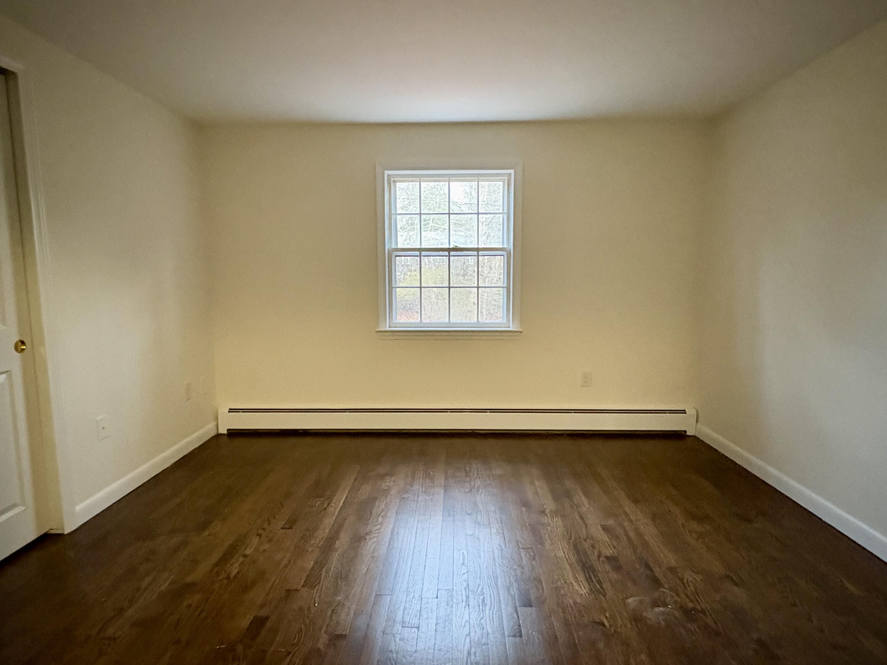 55 Chickadee Lane Centerville, MA 02632 - Photo 16 of 26 an empty room with wooden floor and window
