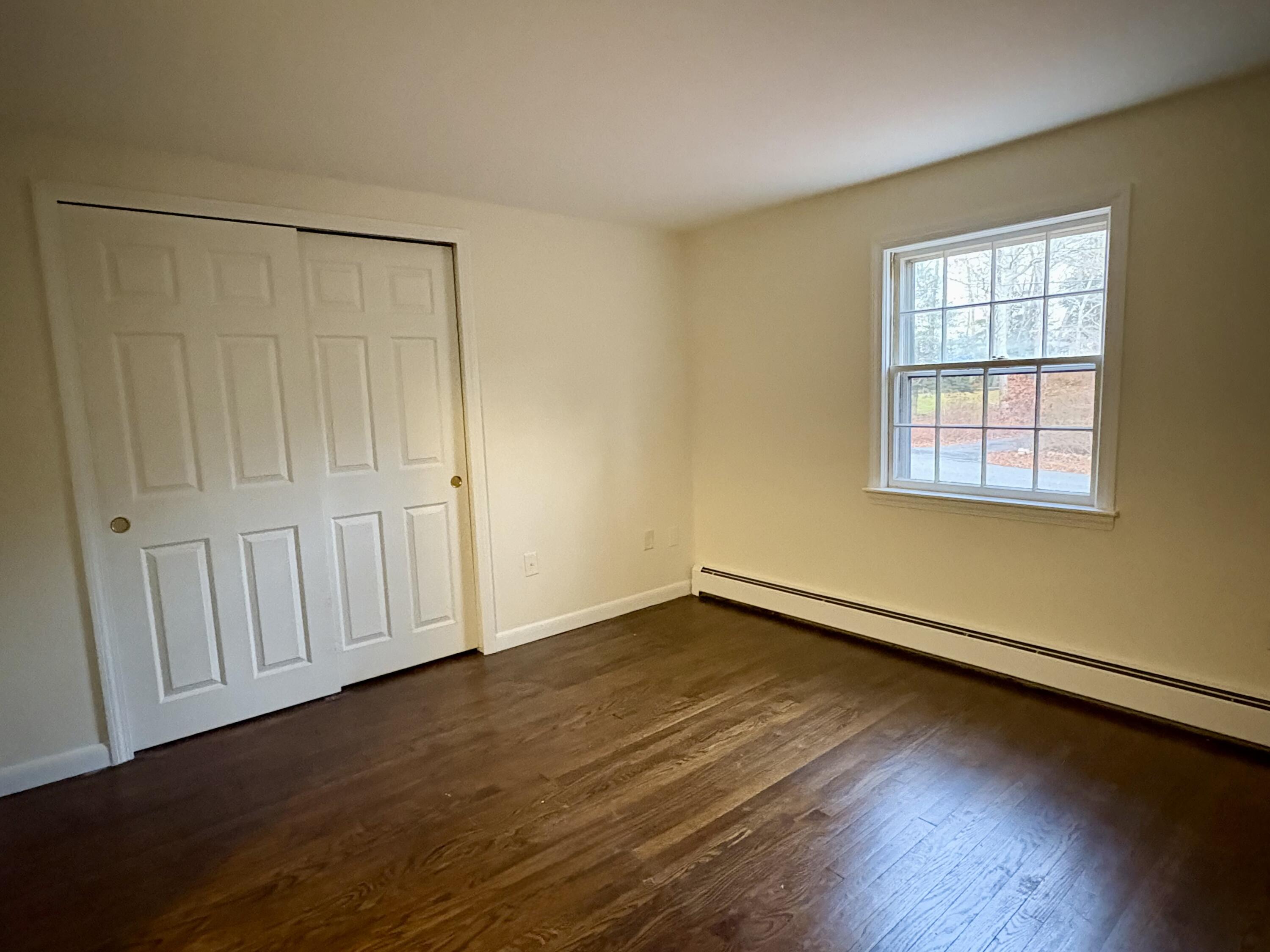 55 Chickadee Lane Centerville, MA 02632 - Photo 17 of 26 a view of an empty room with wooden floor and a window