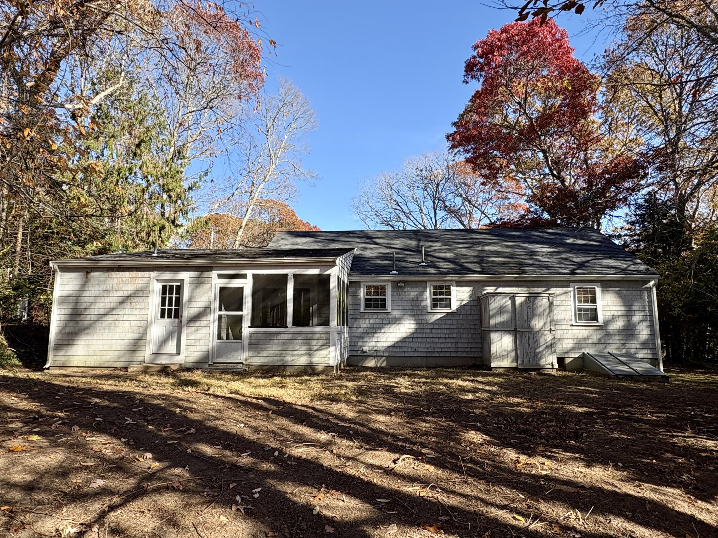 55 Chickadee Lane Centerville, MA 02632 - Photo 25 of 26 a front view of a house with a yard