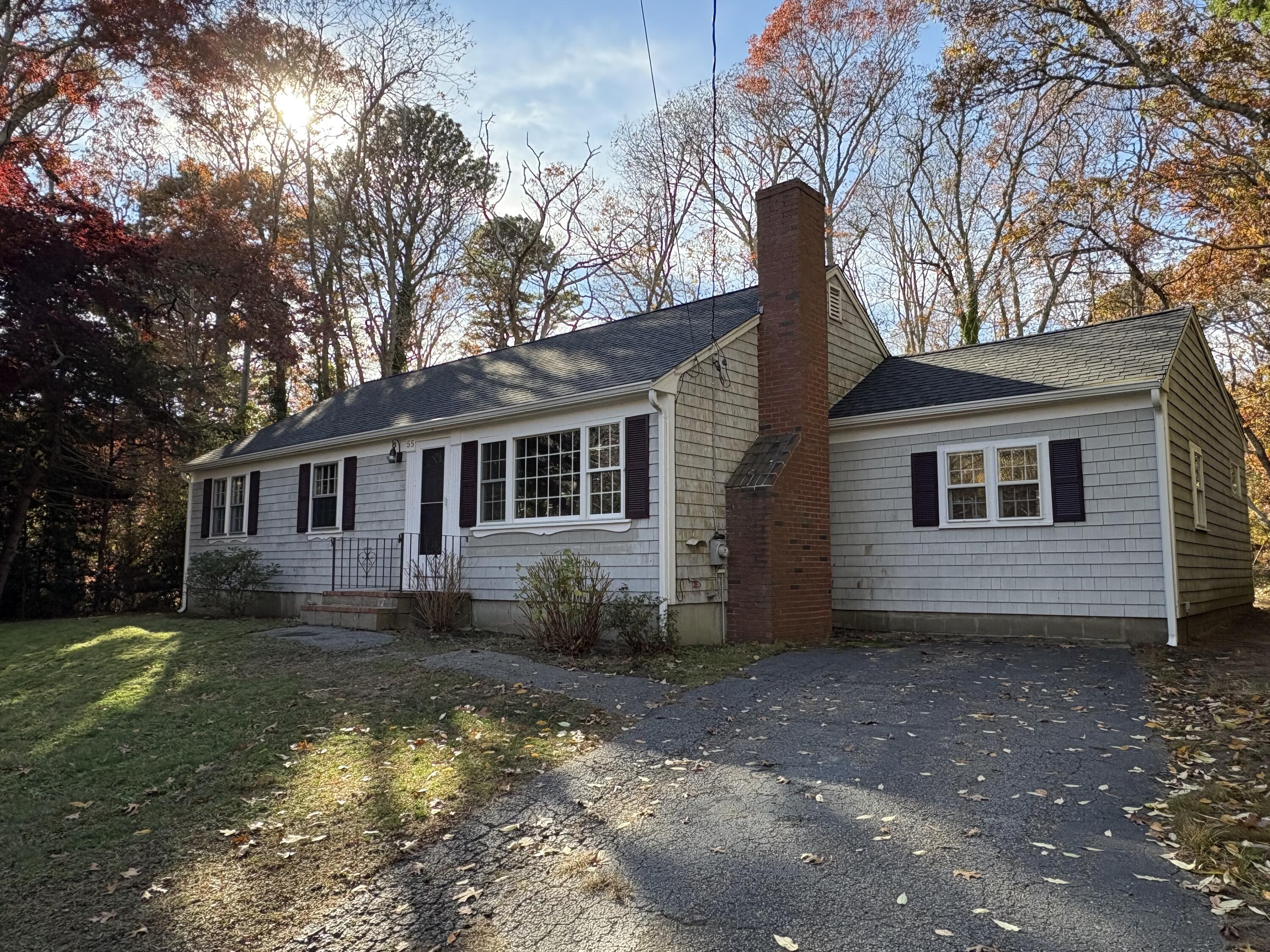 55 Chickadee Lane Centerville, MA 02632 - Photo 4 of 26 a front view of a house with garden
