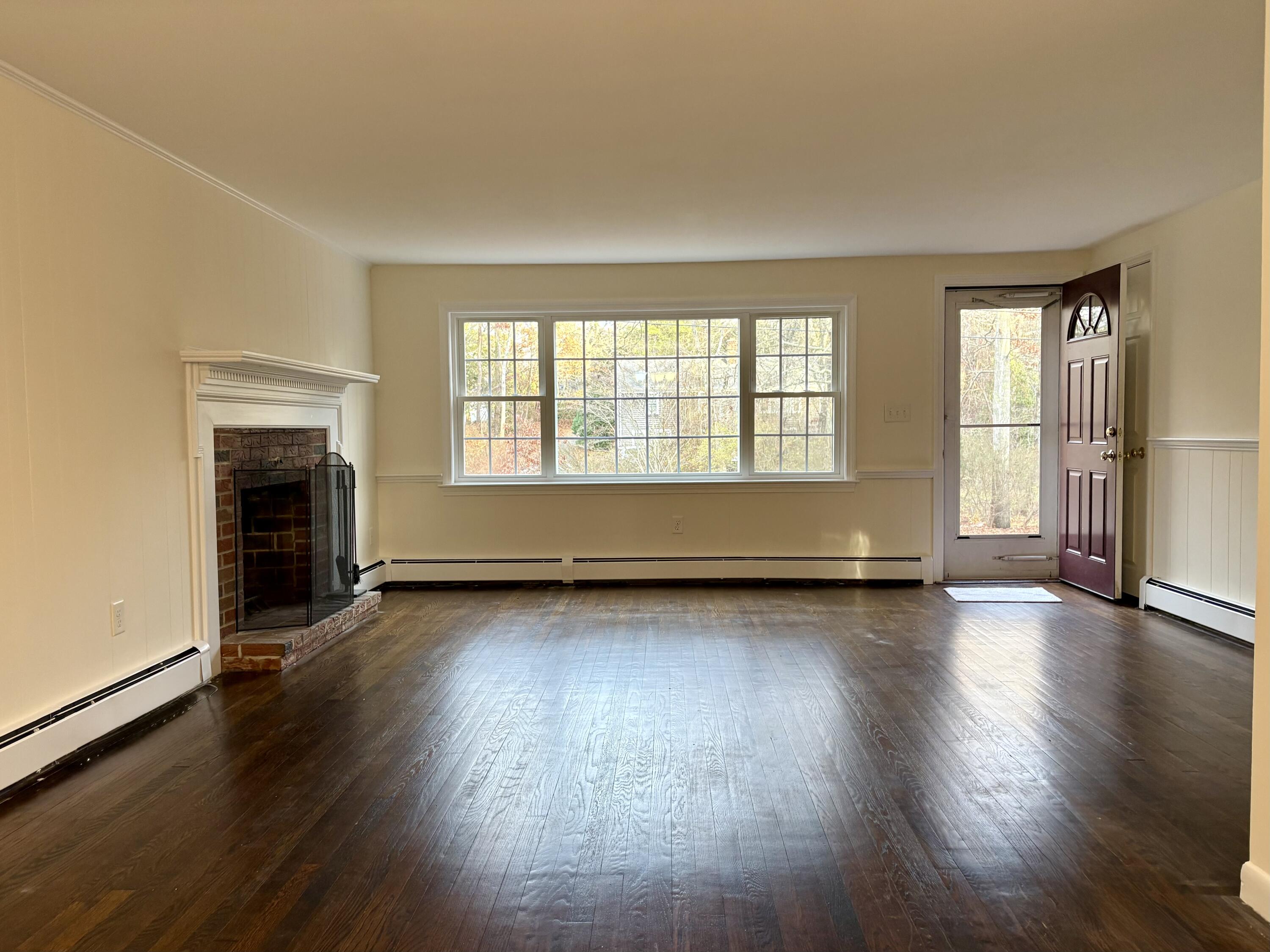 55 Chickadee Lane Centerville, MA 02632 - Photo 6 of 26 an empty room with wooden floor and windows