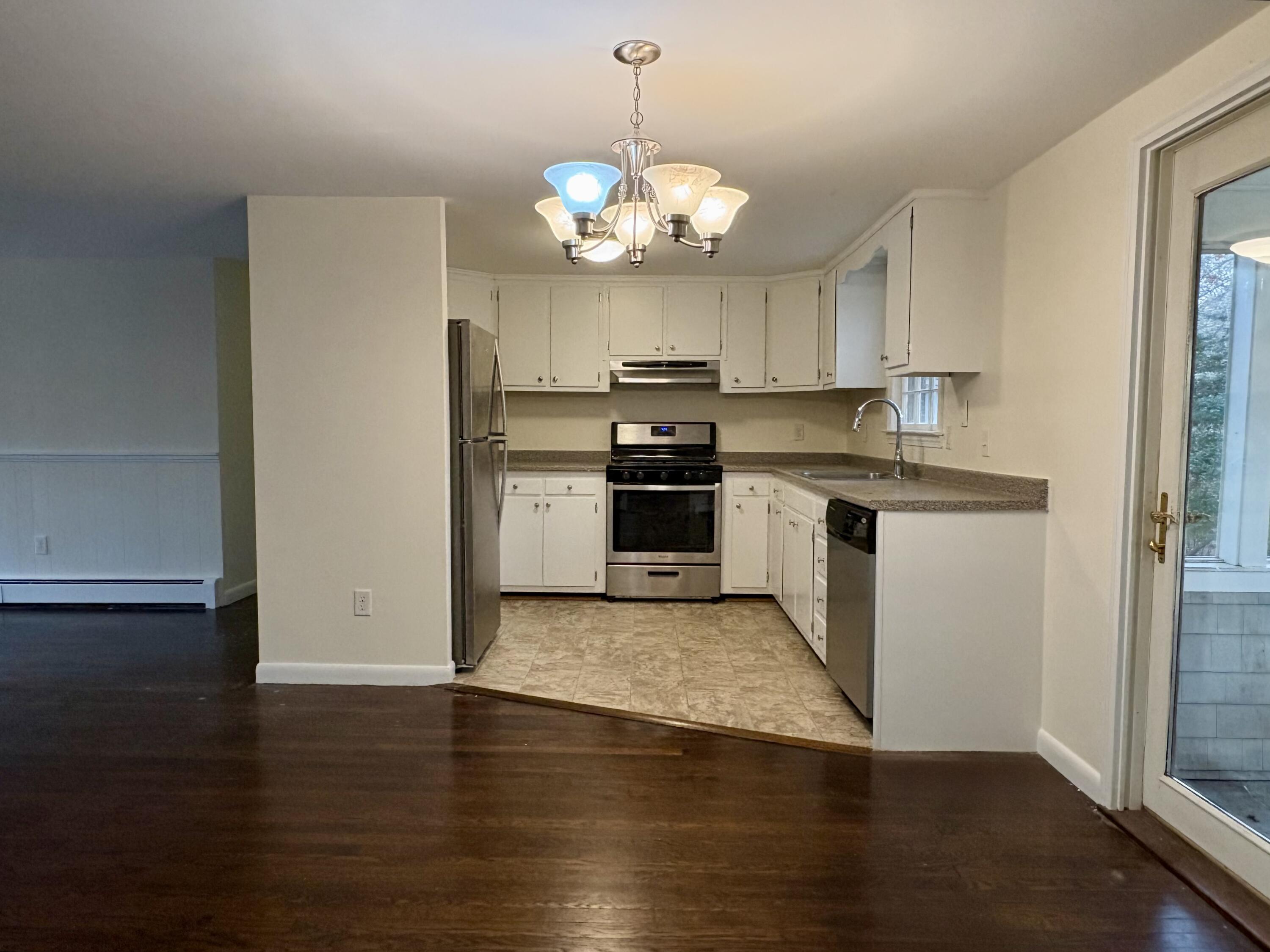 55 Chickadee Lane Centerville, MA 02632 - Photo 9 of 26 a kitchen with stainless steel appliances granite countertop a sink a stove a refrigerator and a microwave
