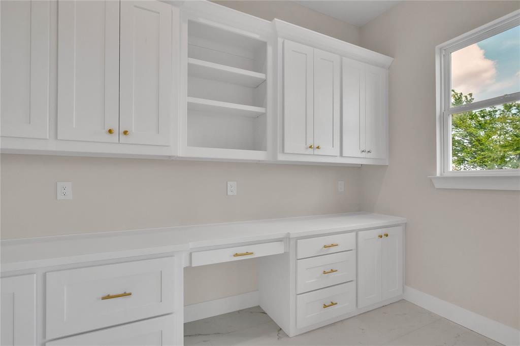 1028 Henry Way Springtown, TX 76082 - Photo 14 of 40 a kitchen with white cabinets and a window