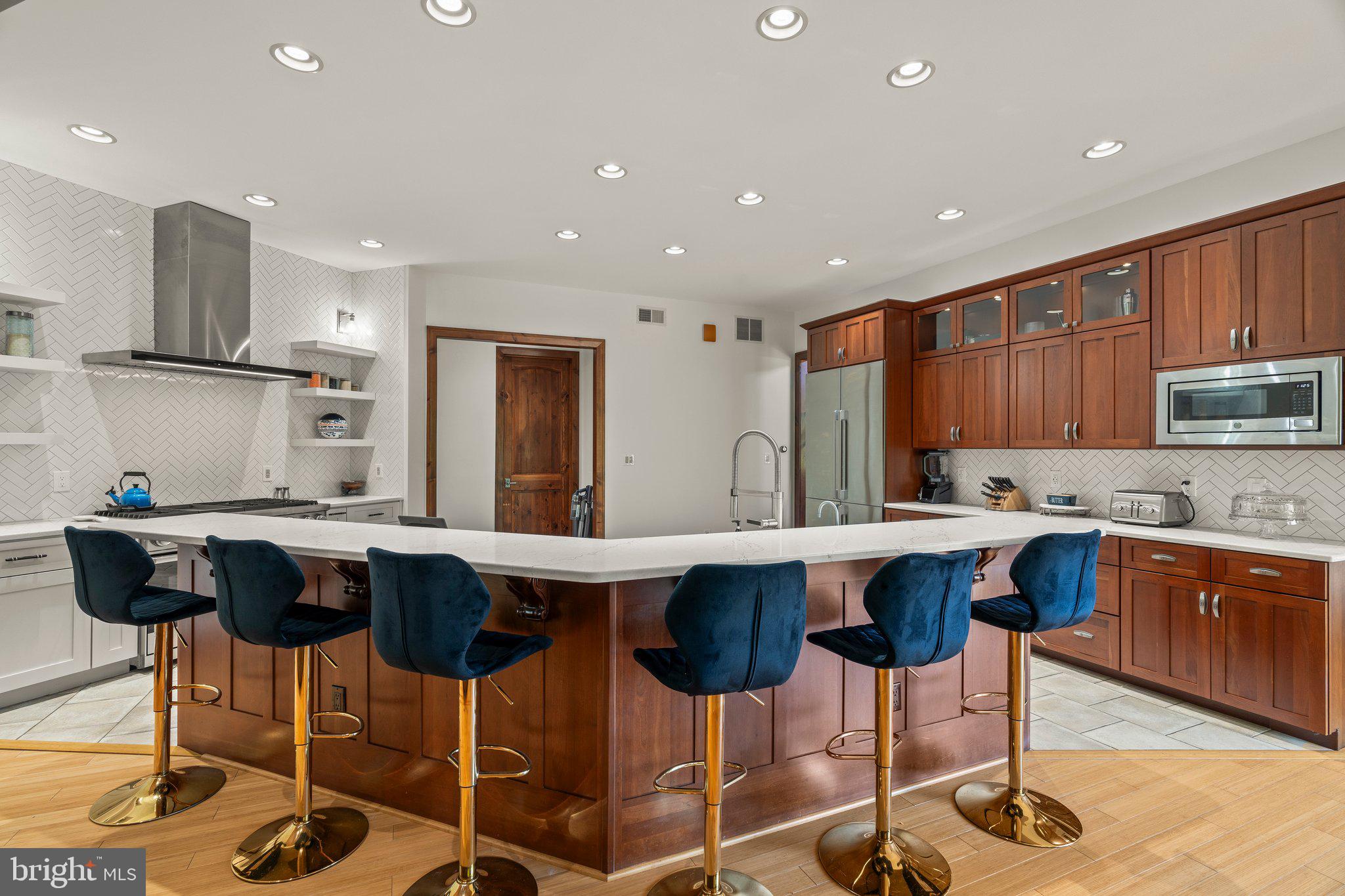 477 Heritage Sewell, NJ 08080 - Photo 17 of 64 a kitchen with stainless steel appliances granite countertop a sink a stove a refrigerator and chairs