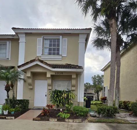 a front view of a house with plants