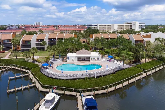 a view of a swimming pool with outdoor seating and a garden