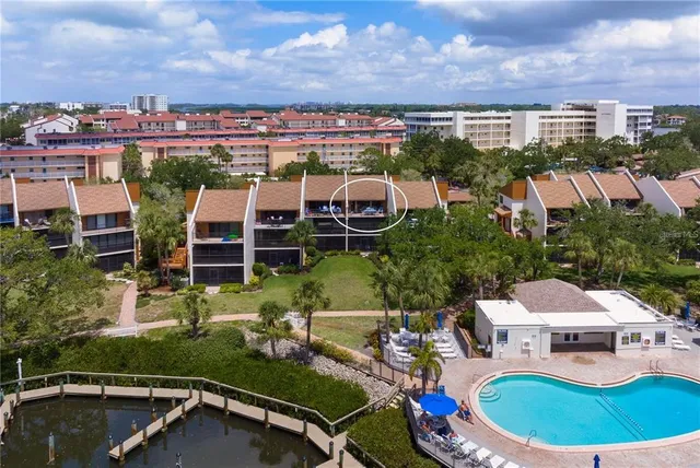 an aerial view of a house with a garden and lake view