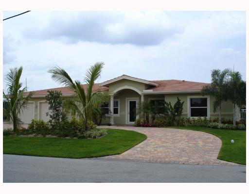 4130 Northeast 30th Avenue Lighthouse Point, FL 33064 - Photo 1 of 15 a front view of a house with a garden and trees