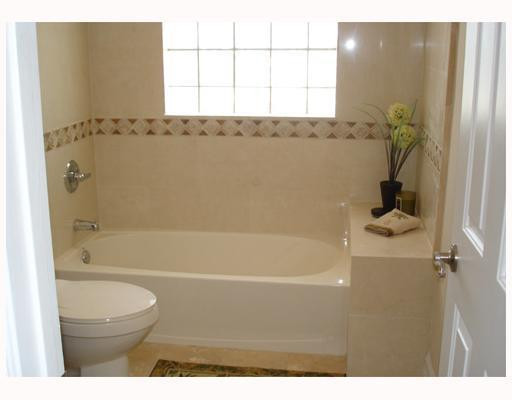 4130 Northeast 30th Avenue Lighthouse Point, FL 33064 - Photo 5 of 15 a bathroom with a bathtub a window and a shower