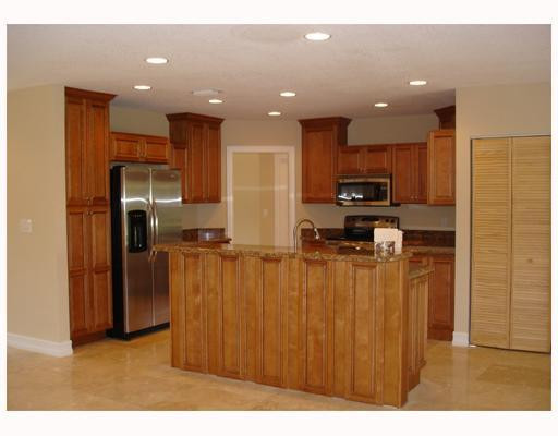 4130 Northeast 30th Avenue Lighthouse Point, FL 33064 - Photo 7 of 15 a kitchen with stainless steel appliances kitchen island granite countertop a refrigerator and a sink