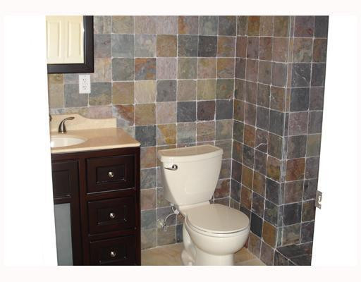 4130 Northeast 30th Avenue Lighthouse Point, FL 33064 - Photo 8 of 15 a bathroom with a granite countertop toilet a sink and a mirror