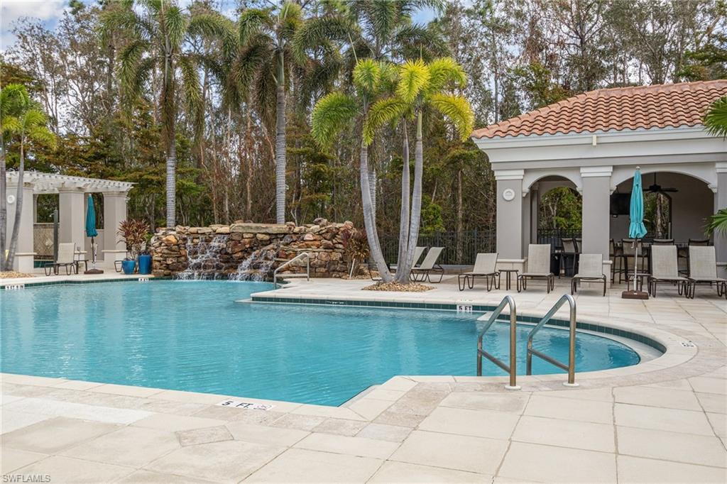 8560 Violeta Street, Unit 104 Estero, FL 34135 - Photo 12 of 12 a view of a swimming pool with outdoor seating