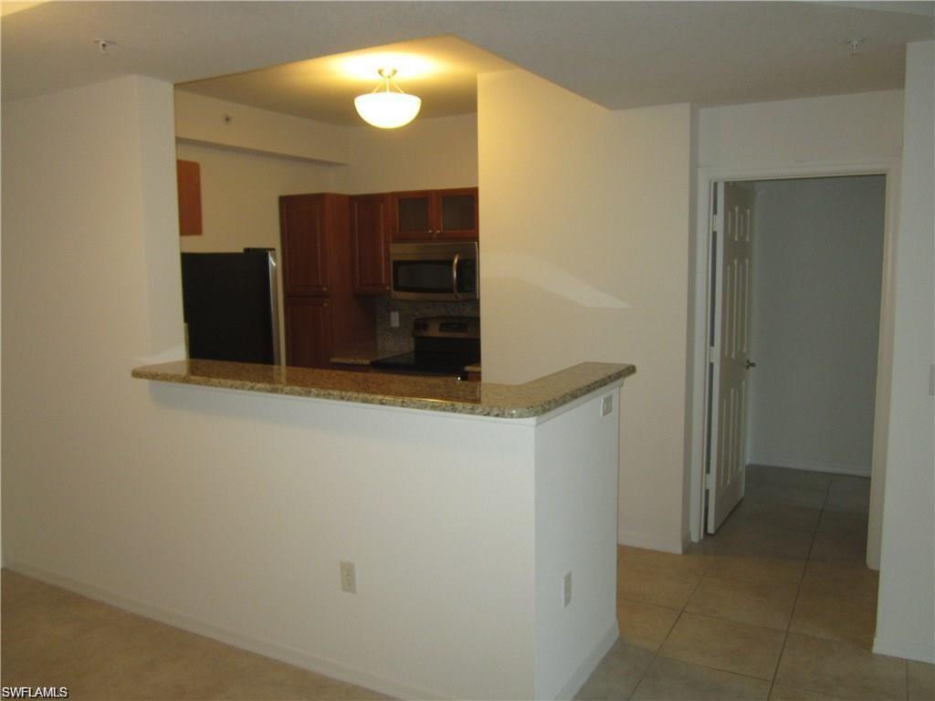 8560 Violeta Street, Unit 104 Estero, FL 34135 - Photo 3 of 12 a bathroom with a mirror and a shower