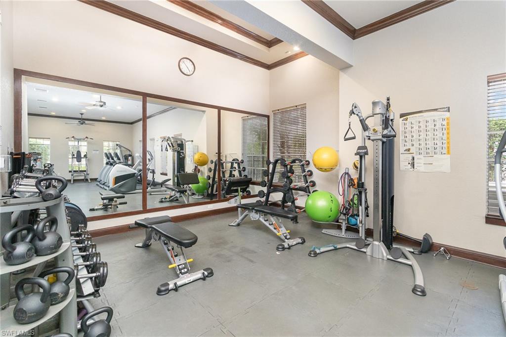 8560 Violeta Street, Unit 104 Estero, FL 34135 - Photo 10 of 12 a room with gym equipment and large mirror