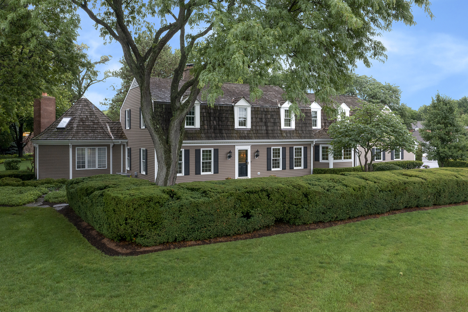 1720 Firth Road Inverness, IL 60067 - Photo 1 of 34 a front view of a house with a garden