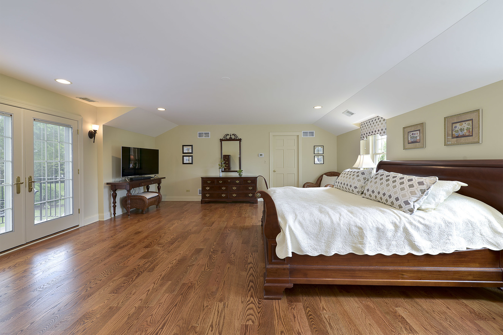 1720 Firth Road Inverness, IL 60067 - Photo 13 of 34 a spacious bedroom with a bed and a flat screen tv