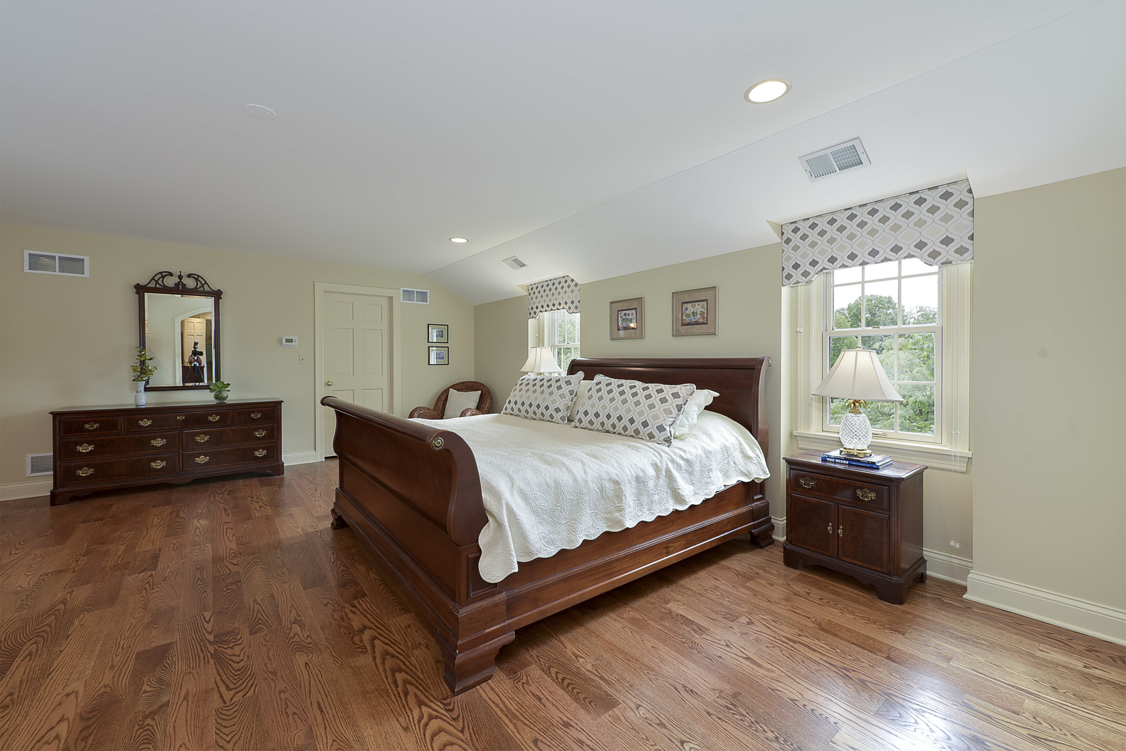 1720 Firth Road Inverness, IL 60067 - Photo 14 of 34 a spacious bedroom with a bed a dresser and a window