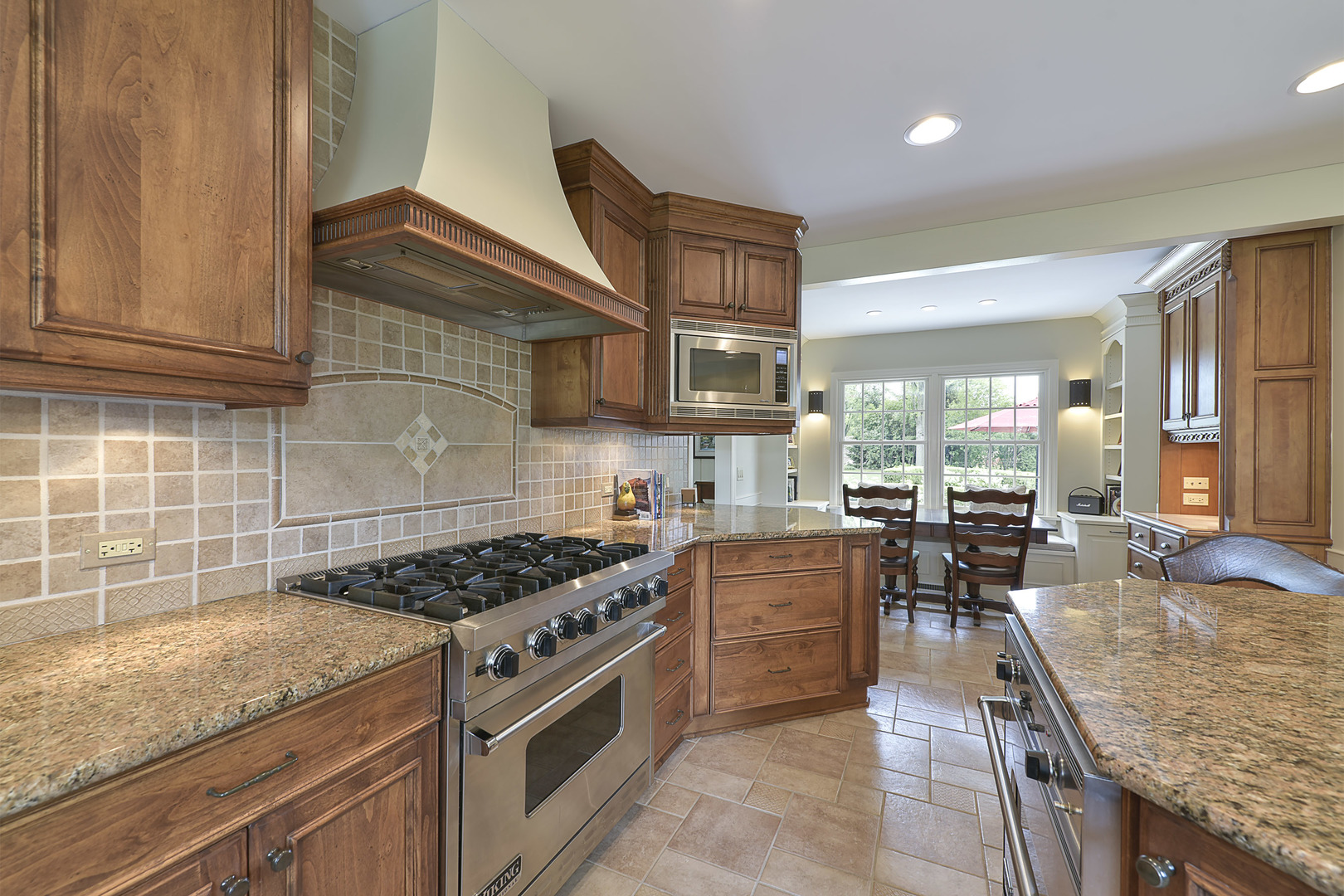 1720 Firth Road Inverness, IL 60067 - Photo 6 of 34 a kitchen with granite countertop stainless steel appliances and wooden cabinets