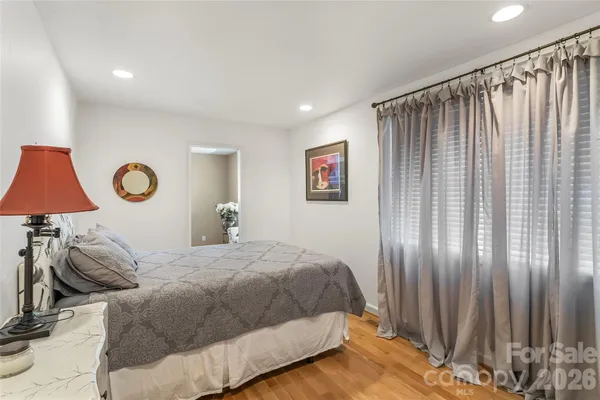 a bedroom with a bed and a lamp