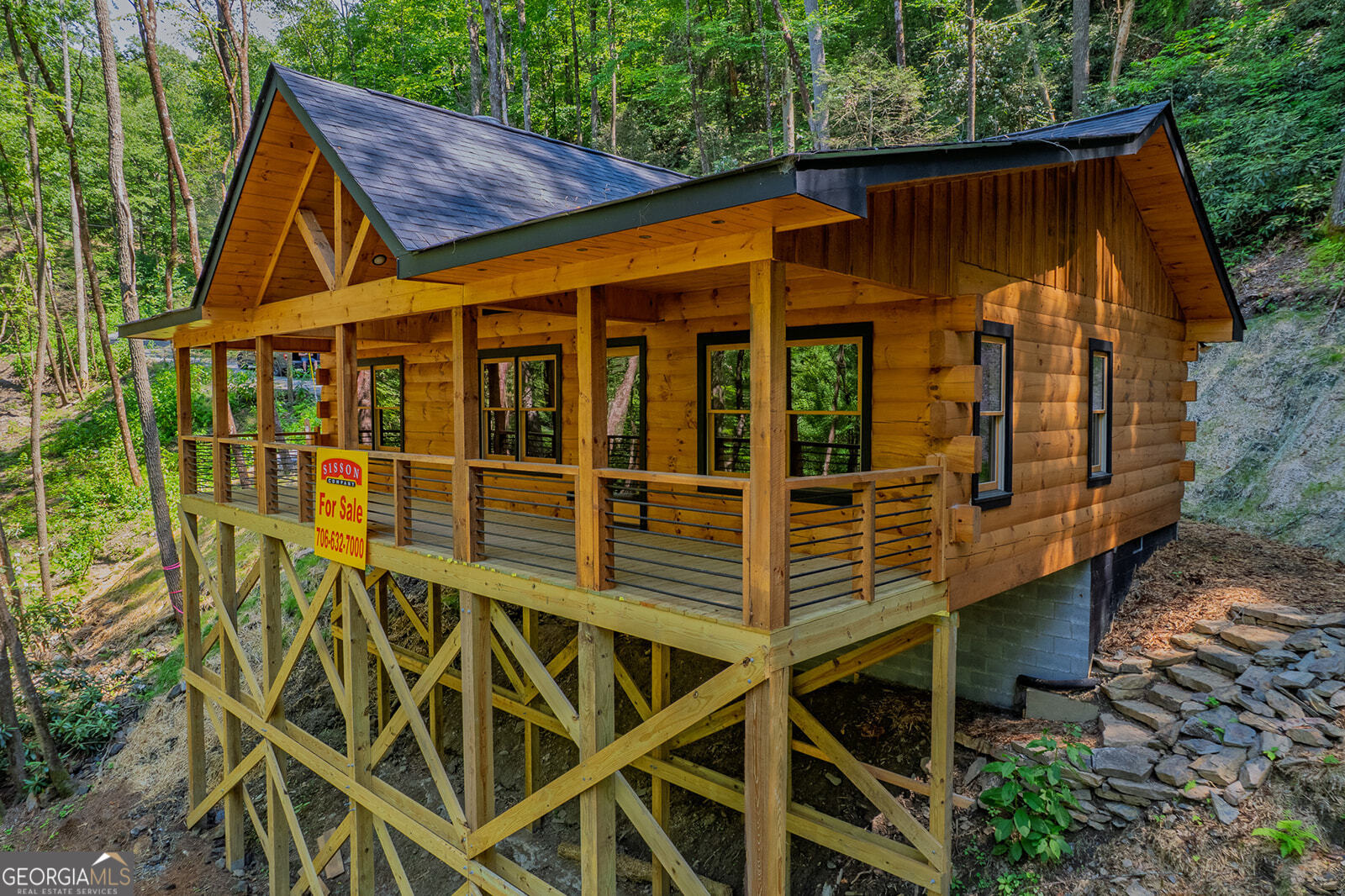 122 Laurel Creek Trail Blue Ridge, GA 30513 - Photo 6 of 18 a blue and white house with a large window and wooden fence