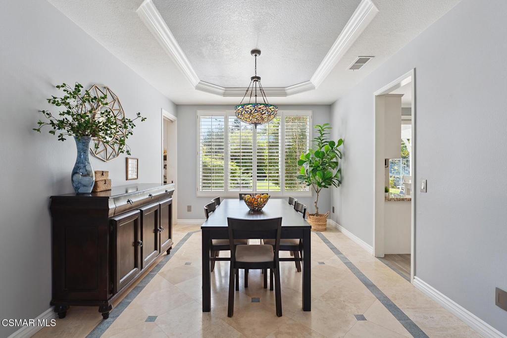 206 Shady Hills Court Simi Valley, CA 93065 - Photo 11 of 84 a dining room with furniture potted plants and a chandelier