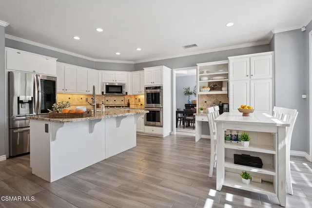 a living room with furniture a table and a chandelier