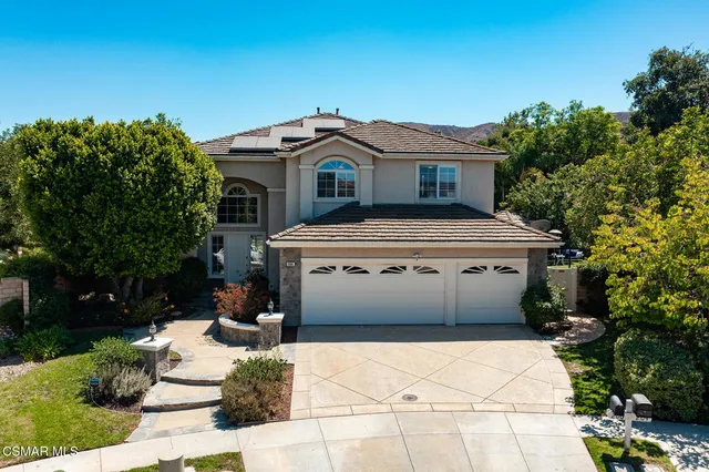 front view of a house with a potted plant