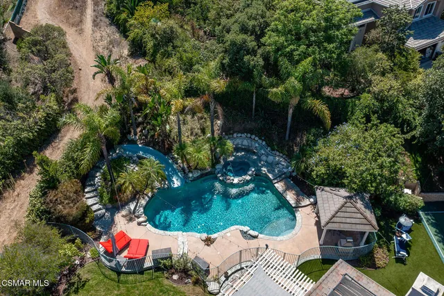 an aerial view of a city with lots of residential buildings and mountain view in back
