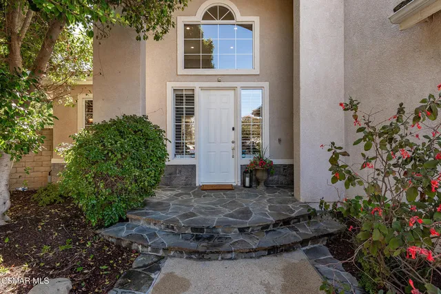 a living room with furniture and a painting on the wall