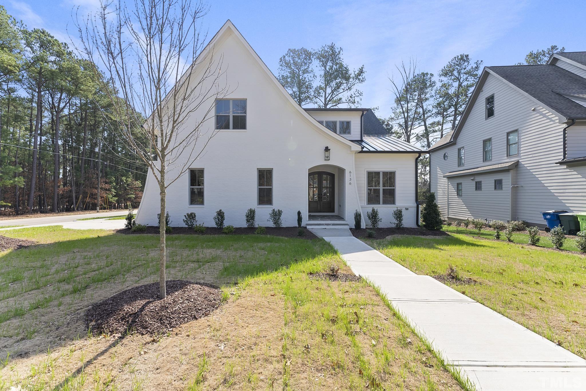 6136 Ponderosa Road Raleigh, NC 27612 - Photo 1 of 42 a view of a white house with a yard and plants