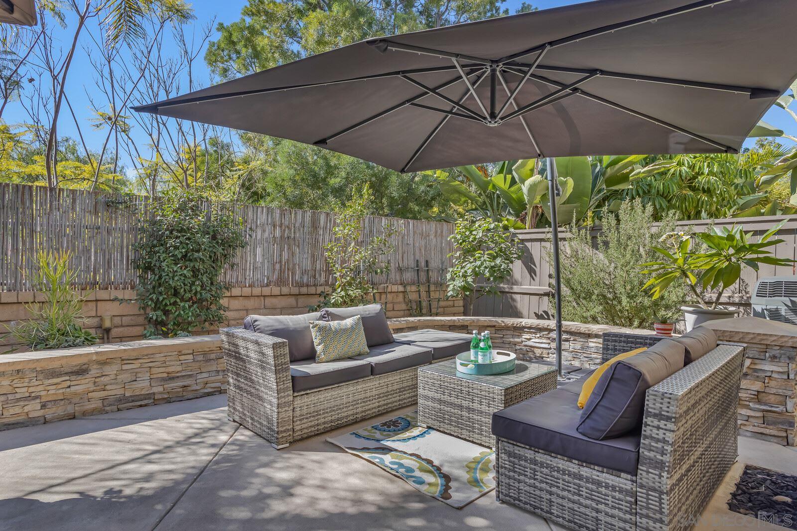 a outdoor living space with furniture and umbrella